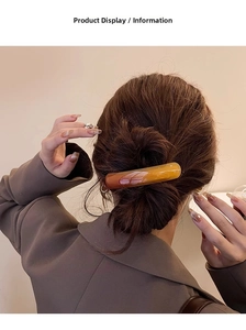 Detail of amber and caramel gradient long hair clip on a minimalist resin spring barrette