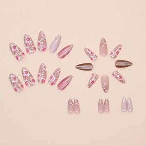 Macro detail of almond pink press-on nails with cat-eye effect and pearl rhinestone accents