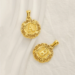 Vintage round gold initial pendant with hollow filigree edge and embossed A-B letters