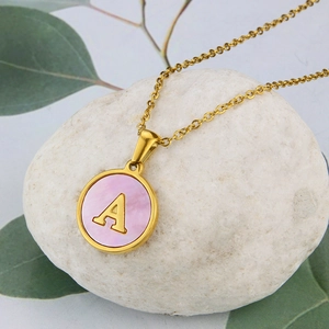 Gold stainless steel necklace with pink shell round pendant and letter A engraving