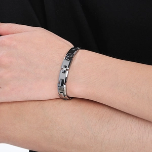 Close-up of adjustable stainless steel H-link bracelet in black and silver on male wrist