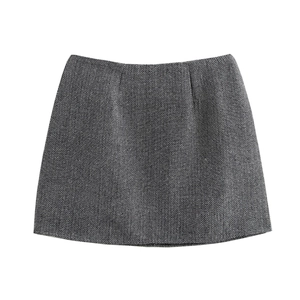 Detail shot of the black and white herringbone pattern on the wool A-line mini skirt