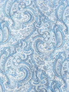 Close-up of blue and white paisley printed textile fabric with high texture quality