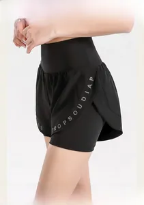 Detail view of high waist black yoga shorts with double layer anti-exposure design