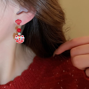 Chinese New Year Lion Dance and Rich charm asymmetric red drop earrings on female model