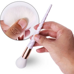 Detail of lavender spiral handle and rose gold ferrule on makeup brush with white bristles