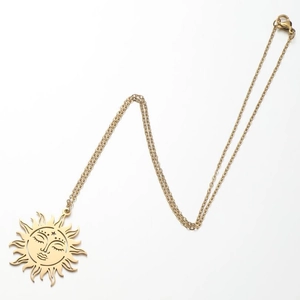 Golden sun face pendant necklace with celestial flame rays and minimalist link chain
