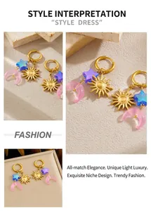 Detail view of gold-plated hoop earrings with celestial star, moon and sun charms