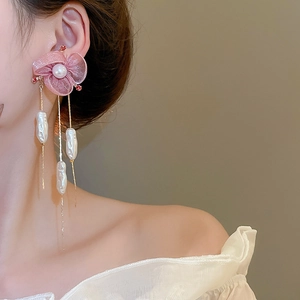 Detailed view of pink chiffon flower earrings with long gold tassels and baroque pearls