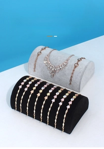 Macro view of velvet jewelry display stands for necklaces and bracelets in grey and black