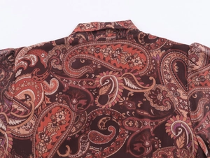 Detail of red paisley chiffon dress featuring a stand collar and lightweight fabric texture