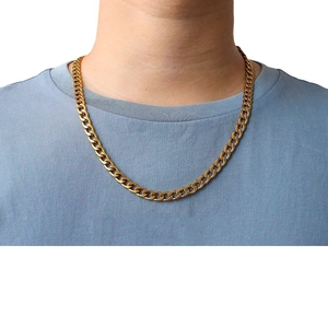 Elegant gold plated stainless steel Cuban link chain necklace worn on a model in white background