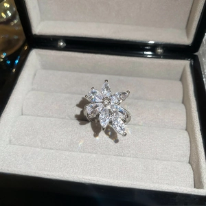 Macro view of French style oval zircon flower ring in a grey velvet jewelry gift box