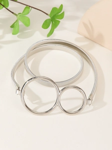 Close-up of silver elastic metal spring belt featuring a polished double ring buckle