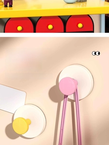 Detail of colorful suction hooks showing removable design for easy home wall organization