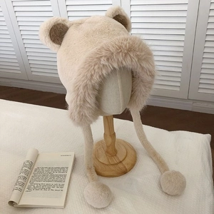 Detail of plush bear ear hat with thickening fleece lining and decorative pompoms
