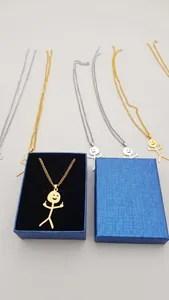 Detailed close-up of funny doodle stickman necklaces with middle finger gesture in gift box