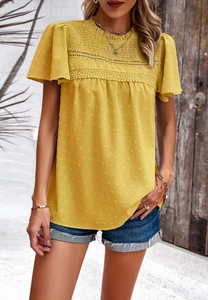 Detail of yellow short sleeve top with polka dot jacquard and delicate lace trim