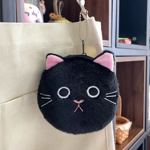 Close-up of black plush cat coin purse with detailed embroidery and metal chain link
