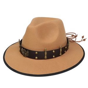 Detail of camel felt cowboy hat featuring leather band with golden bullet metal ornaments