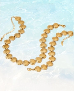Ocean series golden shell necklaces displayed on a light blue water ripple background