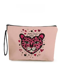 Detail of pink canvas makeup bag with leopard heart print and durable black wrist strap