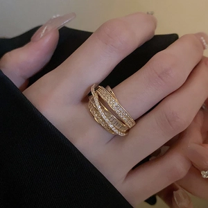 Macro shot of a layered gold ring with sparkling cubic zirconia on a female model finger