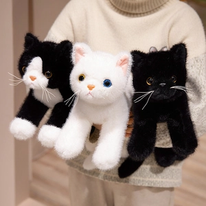 Three realistic plush cats in black, white, and cow patterns held by a person in a home