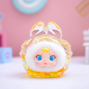 Close-up of yellow resin plush toy figure with sparkling sequins and blue eyes