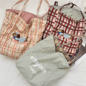 Close-up of vintage plaid canvas tote bag featuring a 3D embroidered dog patch and text