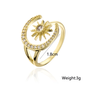 Detail view of gold celestial ring featuring moon and sun design with zircon accents