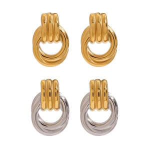 Modern geometric twisted hoop earrings in gold and silver finish on white background