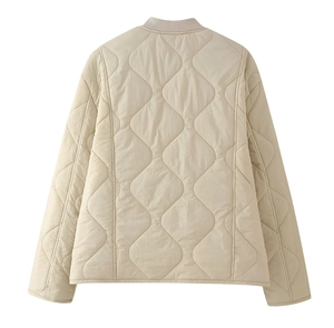 Detailed back view of beige quilted jacket featuring classic diamond stitching pattern