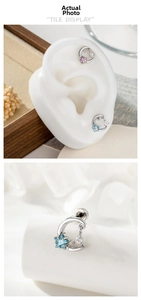 Detail of crescent moon and star piercing stud with colorful cubic zirconia stones