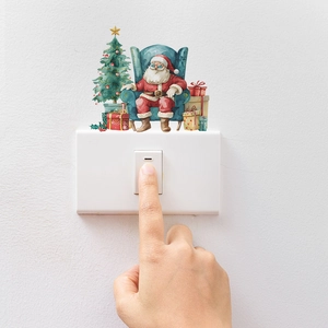 Detailed view of Santa Claus and Christmas tree stickers decorating a light switch