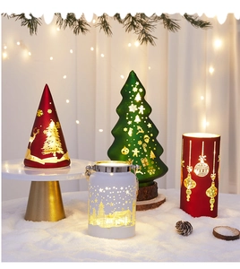 Detailed view of Christmas glass lanterns with festive patterns on artificial snow