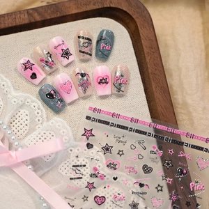 Pink and black punk style nail art stickers with star patterns on a decorative tray