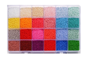 Overhead view of a 24-grid organizer box filled with colorful glass seed beads for DIY crafts