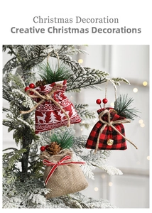 Detailed view of Christmas burlap gift bags with pine cones and berries on tree branches