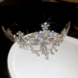 Silver flower crown headband with sparkling crystal tassels and intricate rhinestone patterns
