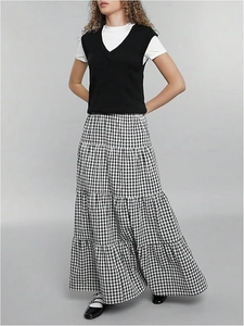 Detailed view of black and white tiered gingham maxi skirt with retro aesthetic