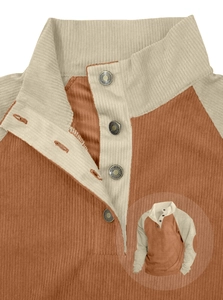 Detail view of men's corduroy Henley shirt showing textured fabric and elbow patches