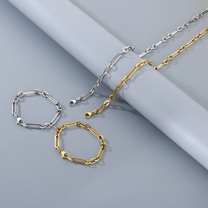 Detailed view of paperclip link necklace and bracelet set in gold and silver steel finish