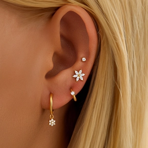 Macro shot of gold s925 silver floral earrings set with opal and cubic zirconia