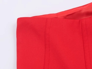 Detailed close-up of stitching and weave texture on a red double-breasted suit set