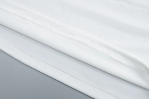 Detailed close-up of the double-stitched hem on a white sleeveless mesh maxi dress