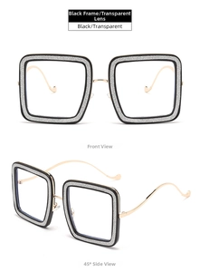 Detail view of square black frame glasses with silver glitter and gold metal temples