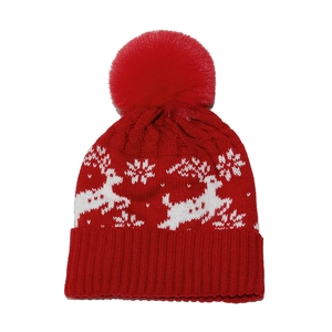 Red Christmas knit beanie with pompom, white reindeer and snowflake jacquard patterns