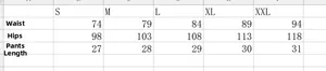 Size chart for solid color cargo denim shorts with waist, hip, and length measurements