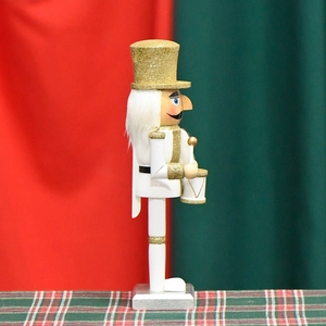 26cm white and gold drummer nutcracker soldier with glitter detail on festive backdrop